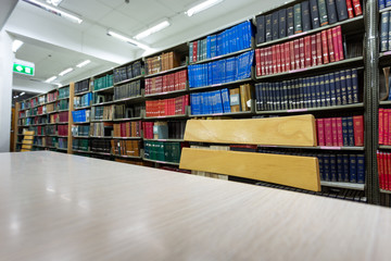 Obraz premium book on desk in library with book column background