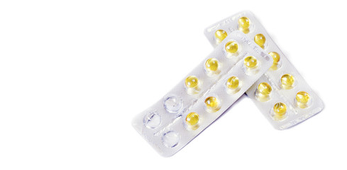 yellow medical pills or capsules or dragees white table