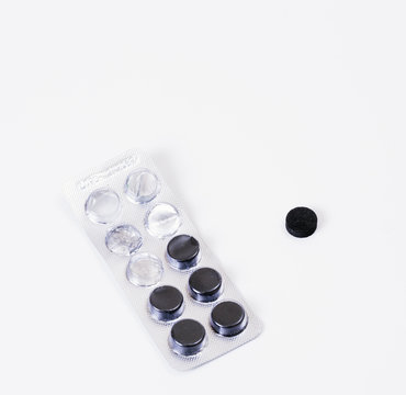 black pills on white table