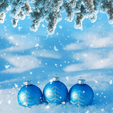 Winter background with three christmas balls in the snow