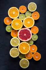 Citrus half cut fruits on dark background
