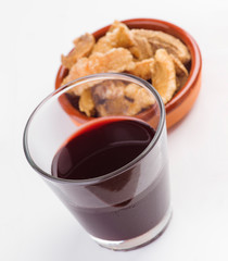 glass of wine and pork rinds