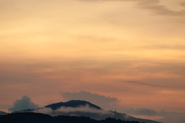 Hills with fog at sunrise