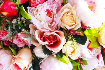 Colorful artificial flowers texture, background