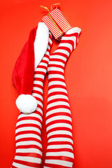 Sexy Santa woman legs with Christmas cap and gift