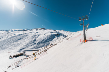 Ski lifts durings bright winter day