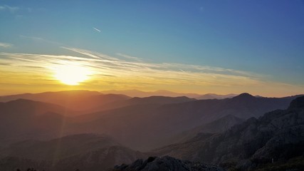 Naklejka na ściany i meble Beautiful panoramic view in the mountain. Sunset shot.