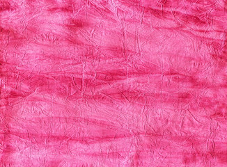 Texture of the wrinkled paper as a background. Pink color,