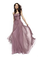 Brunette model in violet dress posing
