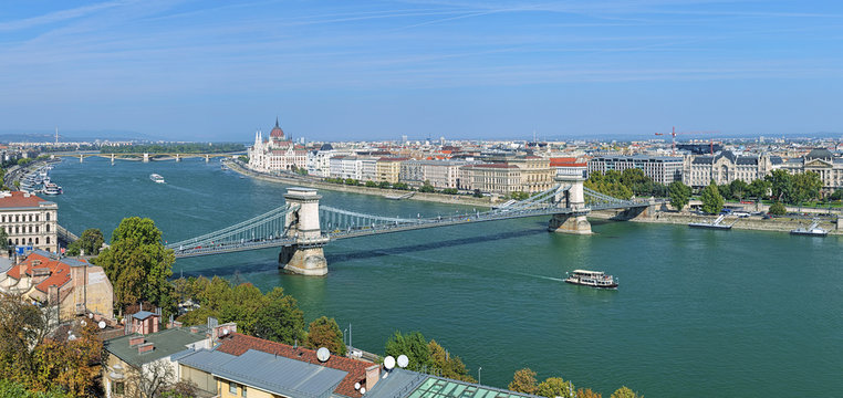 View of the Szechenyi Chain Bridge over Danube and the Hungarian Parliament Building in Budapest, Hungary