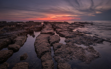 Sunset Over the Sea with Rocks in Foreground