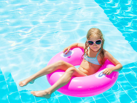 Girl on inflatable ring in swimming pool