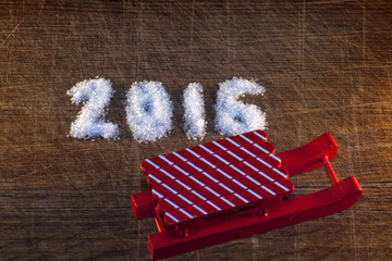 Happy new year 2016 written sugar on wooden background
