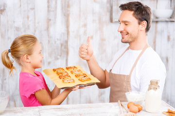 Happy daughter and father baking  