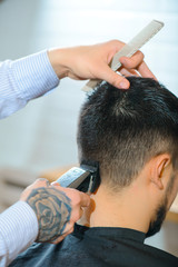 Professional barber making haircut 