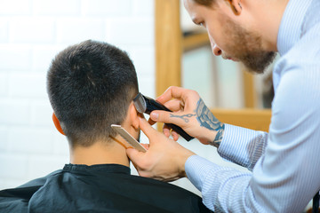 Professional barber holding razor 