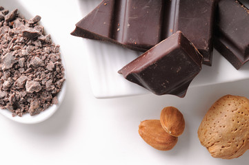Chocolate portions with almonds on a dish close up
