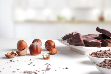 Portions and chocolate chips on containers with hazelnuts in kit