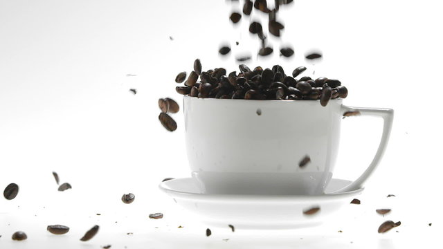 Super Slow Motion Coffee Seeds Falling into White Cup