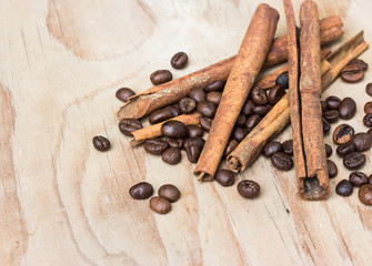 cinamon and coffee beans on wooden table.