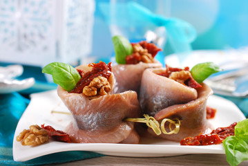 appetizer of herring rolls with dried tomato and walnuts for chr