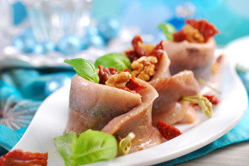 appetizer of herring rolls with dried tomato and walnuts for chr