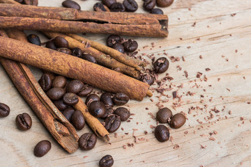 chocolate, cinamon and coffee beans on wooden table.
