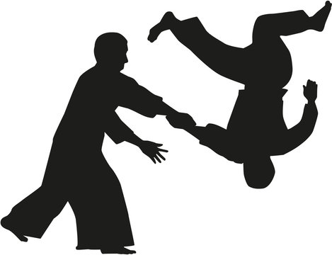 Silhouette of two aikido fighters