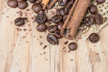chocolate, cinamon and coffee beans on wooden table.