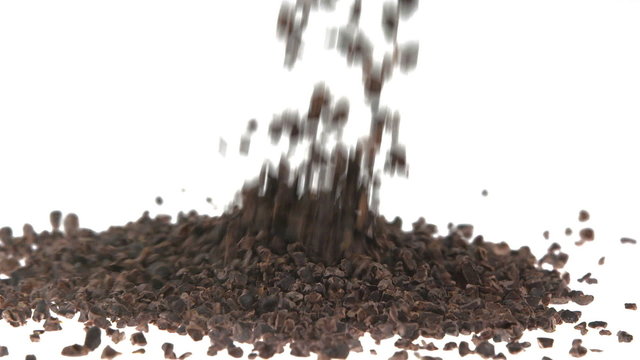 Super Slow Motion Cacao Nibs Falling on White Surface