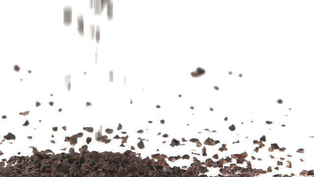 Super Slow Motion Cacao Nibs Falling on White Surface