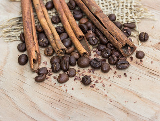 chocolate, cinamon and coffee beans on wooden table.