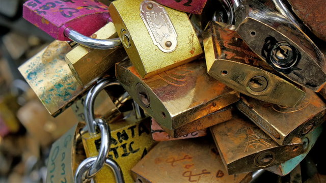 Closer look of the padlocks with names on it. Names of the couples locking the locks in the bridge in Paris