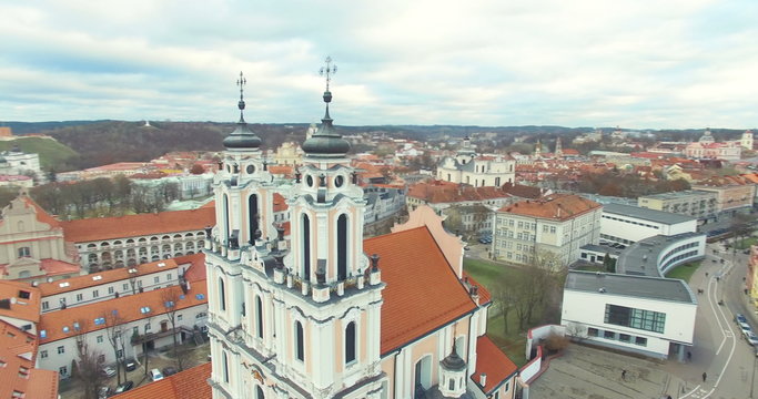AERIAL. Smooth 360 flight around beautiful Church of St. Catherine (Kotrynos) in Vilnius old town, Lithuania. Panorama of Vilnius old town.