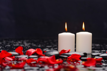 Beautiful rose ,petals with white candle and therapy stones 