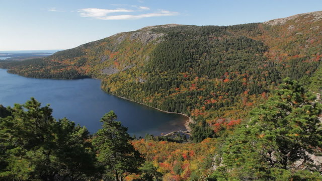 Aerial, panning view of Jordan Pond, Acadia National Park, in Autumn, looking east towards the Atlantic Ocean and the Cranberry Isles. Penobscot Mountain is in the mid-foreground on the right.