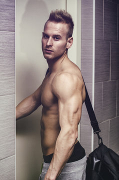 Shirtless Muscular Young Man Opening Door, With Gym Bag