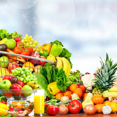 Vegetables and fruits over green background.