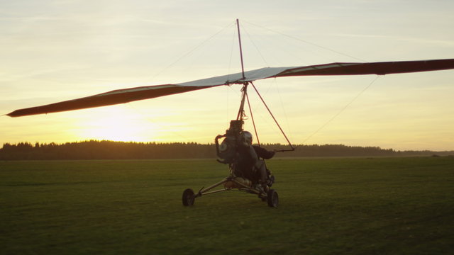 Moving Motorized Deltaplane at Sunset. Shot on RED Cinema Camera.