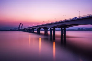 Fototapeten sunrise,sunset skyline and bridge over river © zhu difeng