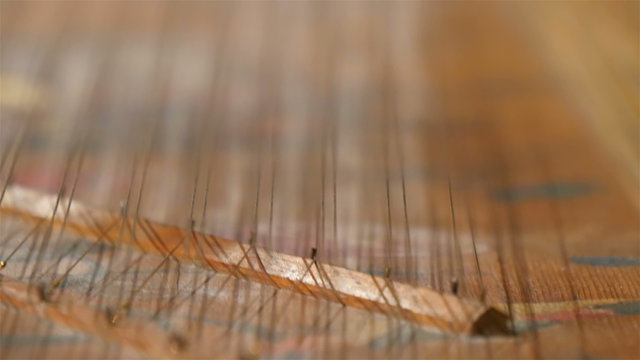 Closer look of the strings of the harp. The thin strings that produces sounds on the instrument