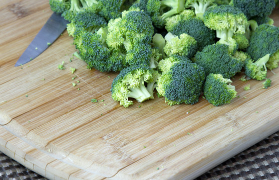 Cut up Broccoli on a wooden board
