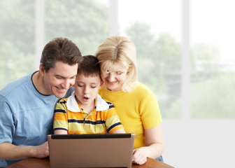 Happy family with laptop computer.