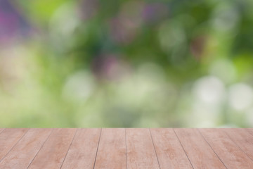 Wood table top on bokeh abstract green background - can be used for montage or display your products