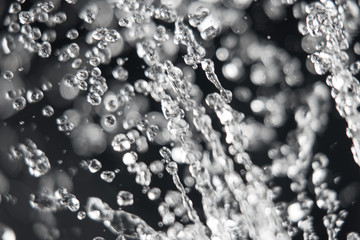 Drops of water in the air on dark background