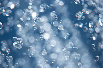 Water drops levitating in the air, blurred and in-focus