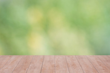 Wood table top on bokeh abstract green background - can be used for montage or display your products