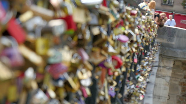 The love locks locked on the bridge. The famous love lock bridge on the river near the Notre Dame Cathedral in Paris