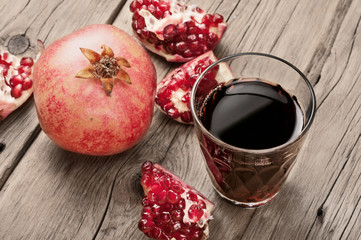 Glass of pomegranate juice with slices of pomegranate