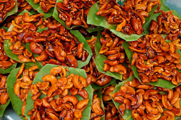 Sugar coated cashew nut on the foliage.